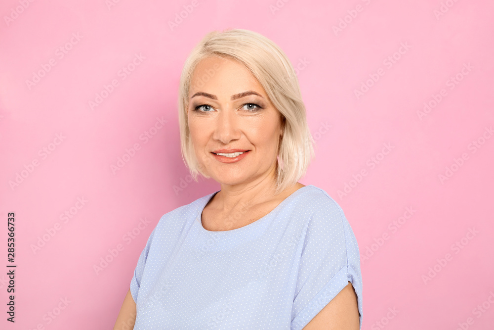 Portrait of mature woman with beautiful face on pink background Portrait of mature woman with beautiful face on pink background