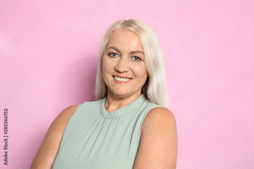 Portrait of mature woman with beautiful face on pink background Portrait of mature woman with beautiful face on pink background