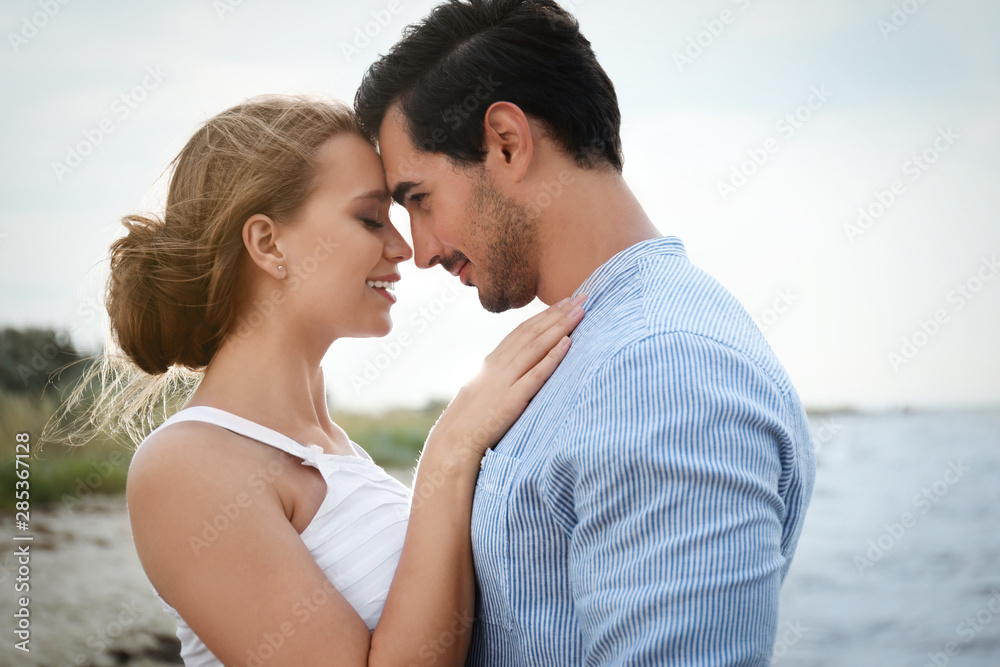 Happy young couple spending time at sea beach Happy young couple spending time at sea beach