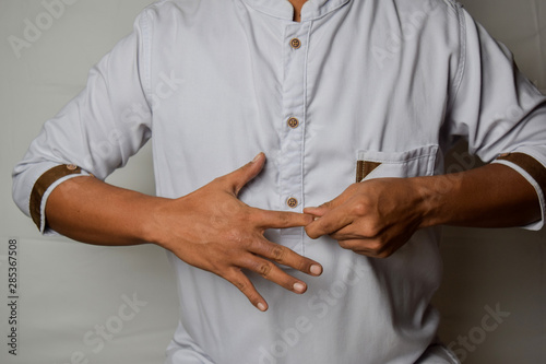 Close up Asian man shows hand gestures it means massaging painful index finger isolated on white background