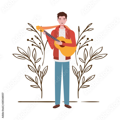 man with acoustic guitar and branches and leaves in the background