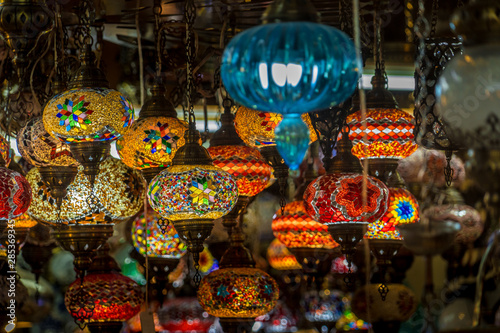 Colorful hanging lamps made out of yellow, blue, red glass in a bazaar