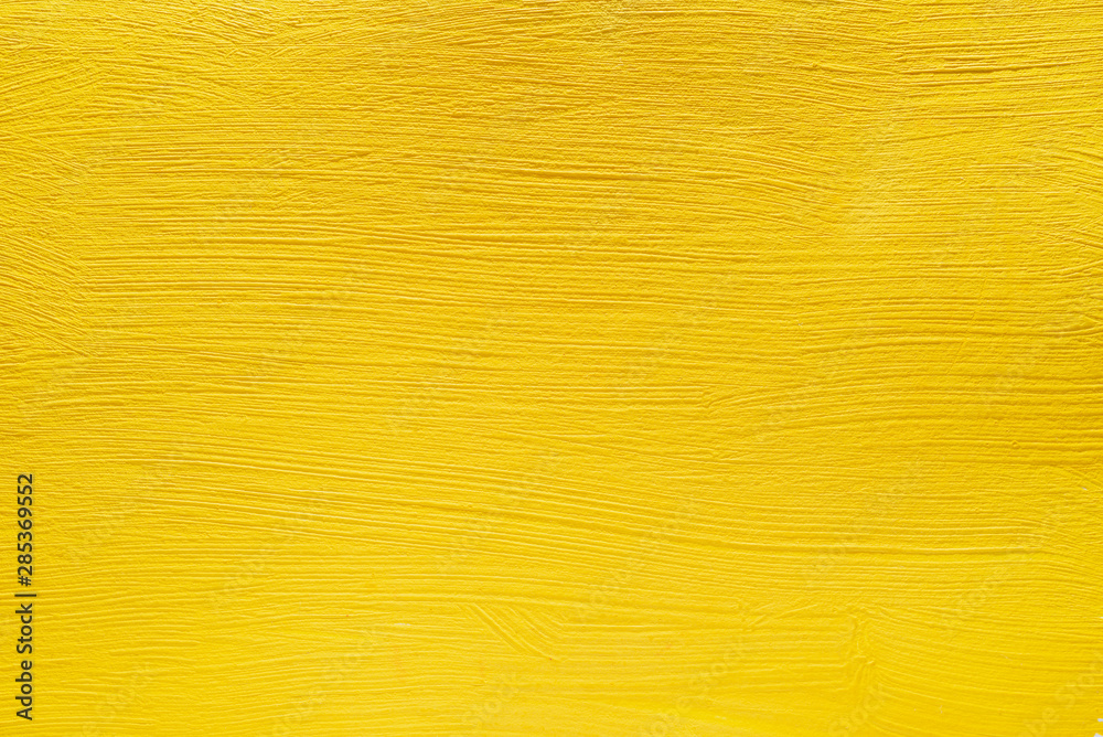 Abstract yellow background from acrylic paints. Concrete background.