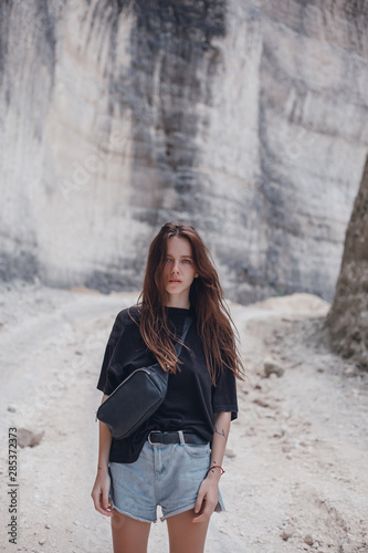 Beauty woman hipster portrait, outdoor fashion model, jeans denim, t shirt, backpack, Bali, backpack hipster, ocean beach, sea view, wild hair, amazing photo, sad moods, waves, crazy girl