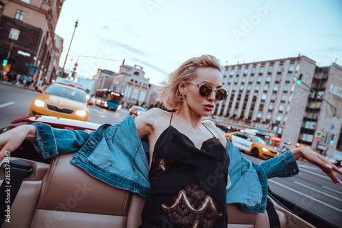 Canvas Print Beauty woman posing with red car in the street,fashion model,outdoor crazy portr