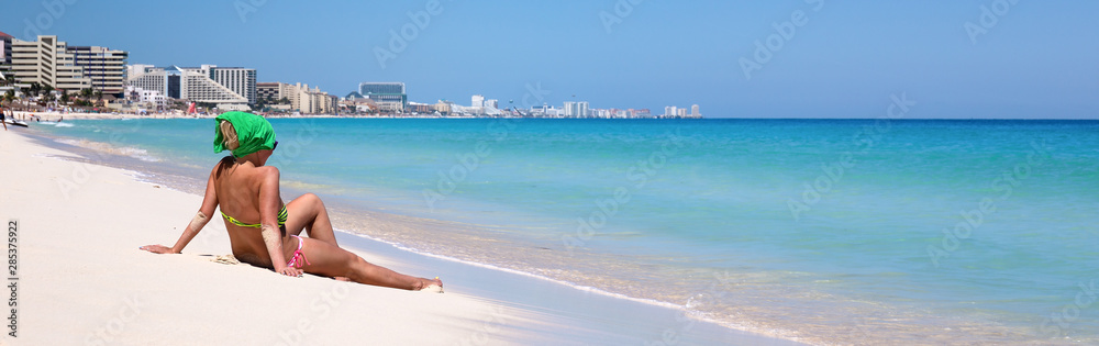 Woman relaxing on sandy beach. Travel destinations
