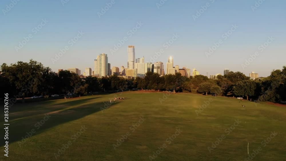 Aerial Drone shot from Zilker Park, going towards downtown Austin, Texas. People in zilker park playing soccer, doing yoga, and being active with their dogs. Aerial Drone shot from Zilker Park, going towards downtown Austin, Texas. People in zilker park playing soccer, doing yoga, and being active with their dogs.