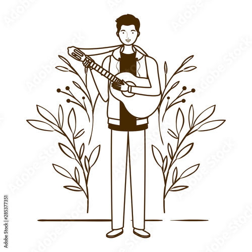 silhouette of man with acoustic guitar and branches and leaves in the background