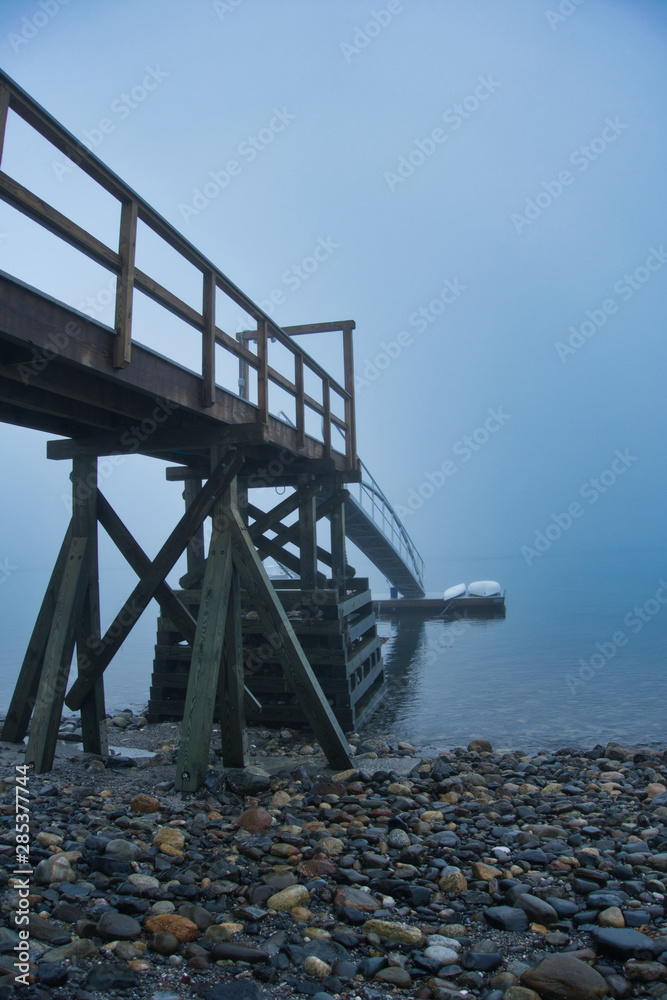 Outside nature photo featuring a boat dock and fog Outside nature photo featuring a boat dock and fog