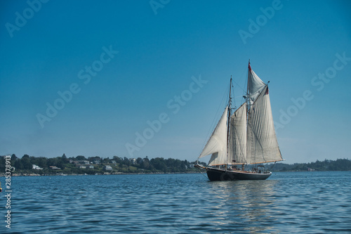 Outside nature photo featuring ocean boat and blue sky