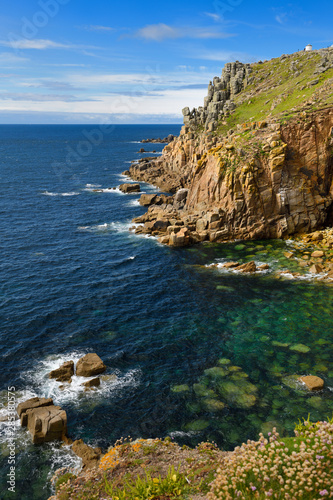 Granite blocks at Trevescan cliff at Land's End Carn Kez from Carn Greeb with blue green water of Greeb Zawn Atlantic Ocean Cornwall England photo