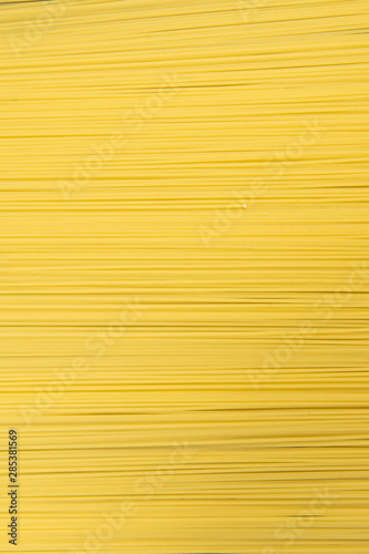 Raw Italian spaghetti pasta on gray background