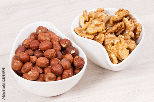 Hazelnuts and walnuts in bowl as source healthy vitamins and minerals, nutritious eating