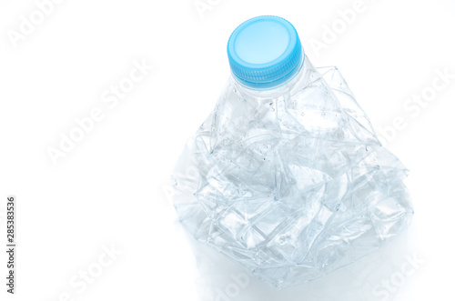 crumpled PET plastic bottle of drinking water, waste plastic bottle to be recycled, recyclable waste concept