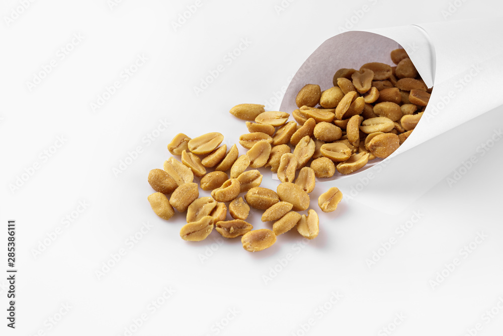 salted peanuts isolated on the white background. salted peanuts isolated on the white background.
