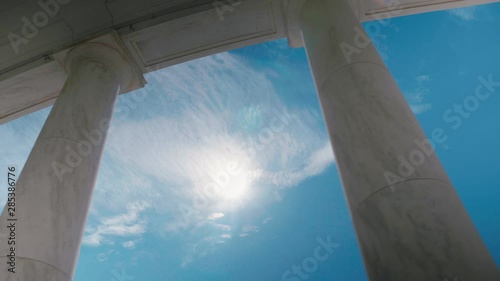 Arlington Cemetery Ampitheater pillars Sun noon Sky Clouds Sliding Shot photo