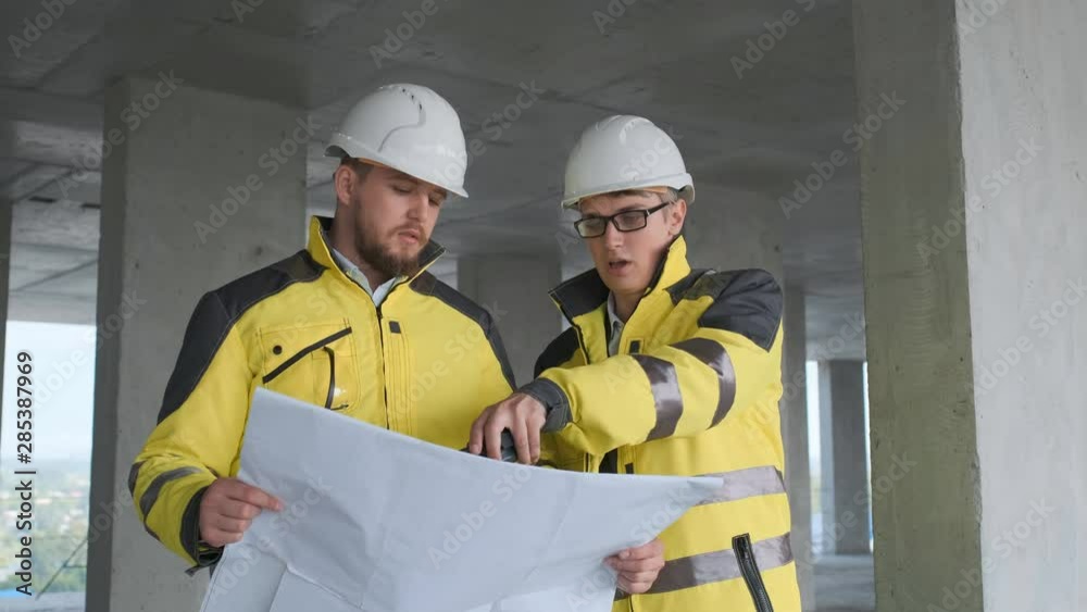 Architect or engineer working, browsing building project indoor of construction site with blueprint plan. businessman worker, man male construction engineers or architects working people. Two Engineer
