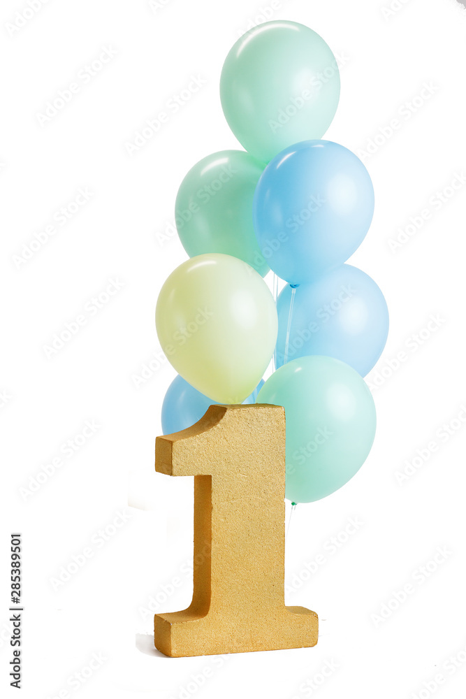 A large bunch of colorful balloons on a white background next to the gold number one. A large bunch of colorful balloons on a white background next to the gold number one.