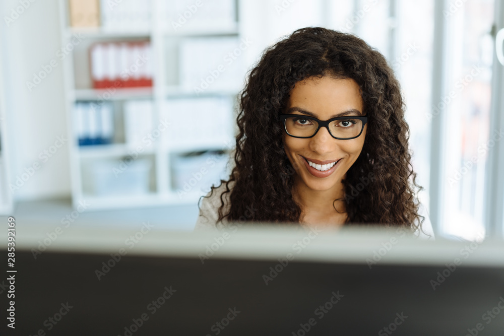 Young businesswoman smiling up at the camera Young businesswoman smiling up at the camera