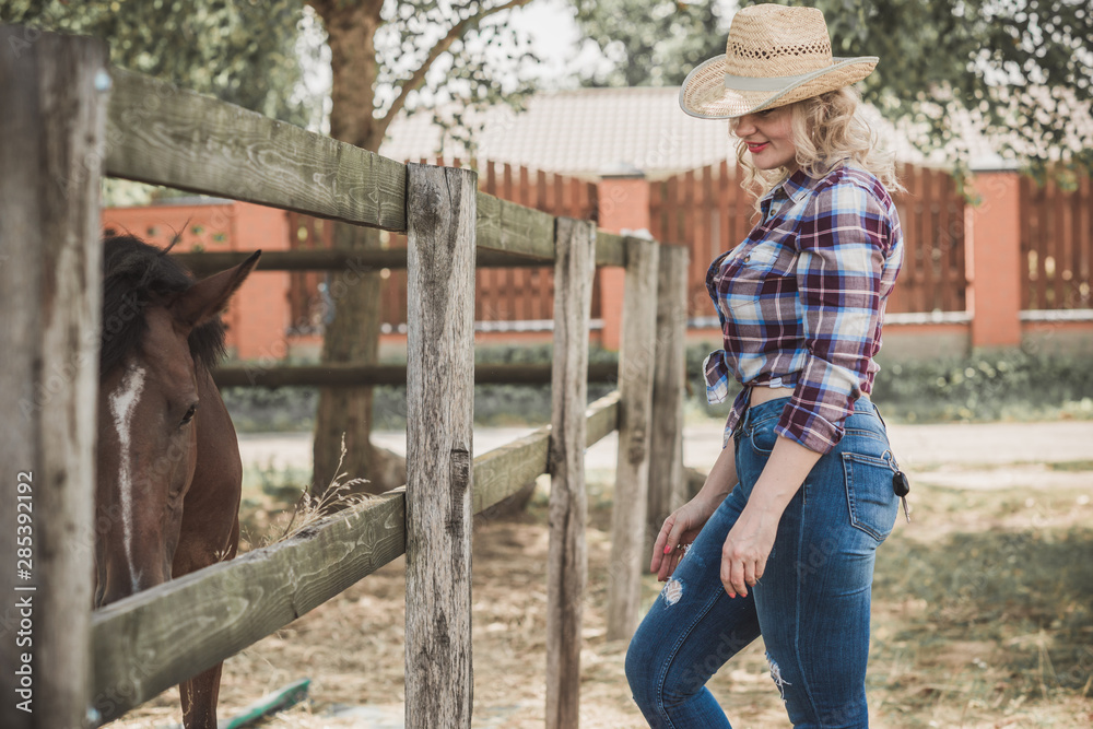Woman with a horses on farm, pets animals in village on a rancho. Horses are human friends Woman with a horses on farm, pets animals in village on a rancho. Horses are human friends
