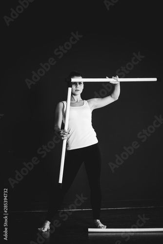 Juggler girl on black background, woman training 
