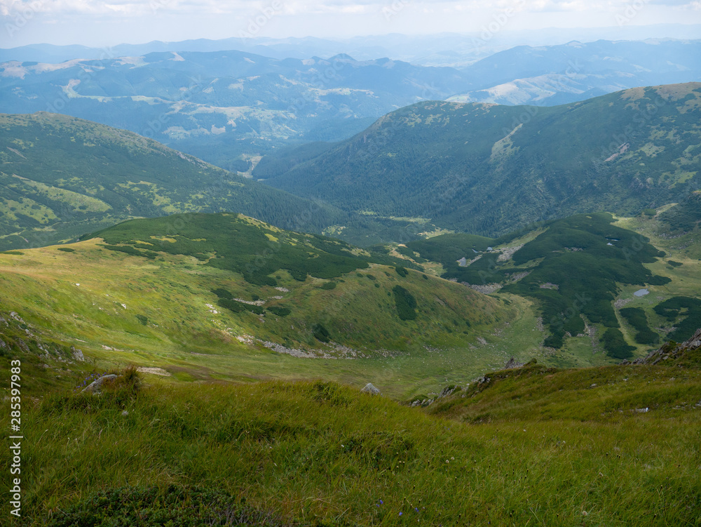Fototapeta premium Mountain valley during sunrise / sunset. Natural summer landscape. Colorful summer landscape in the Carpathian mountains.