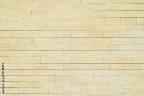 Background of yellow bricks. Wall of yellow bricks. The texture of the wall.