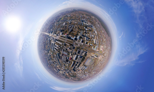 Aerial view of the city with traffic  streets and buildings with green trees and rails under the blue sky with clouds at summer day in Novosibirsk. Panoramic 360 degrees of the panet.