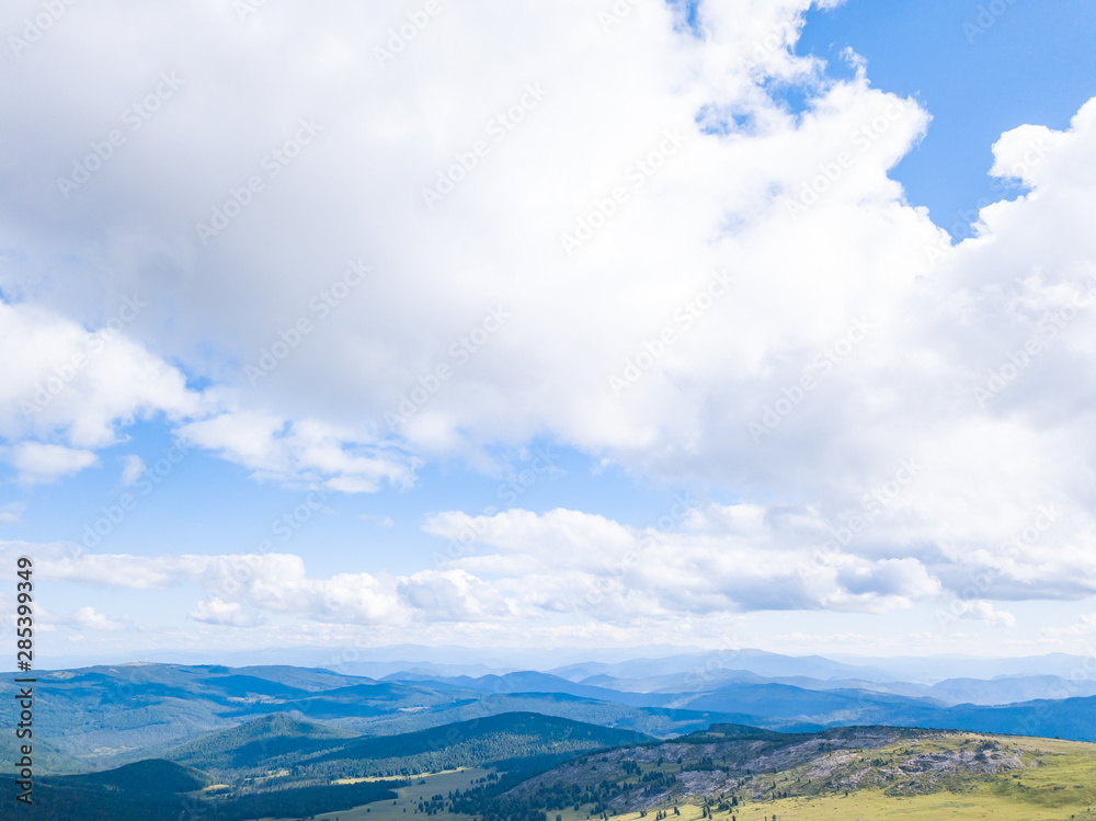 Blue sky with white clouds in mountains in summer