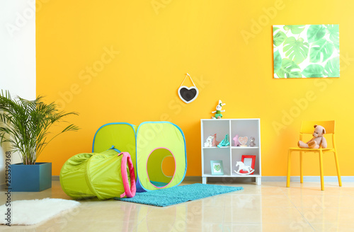 Interior of modern children's room with play tunnel