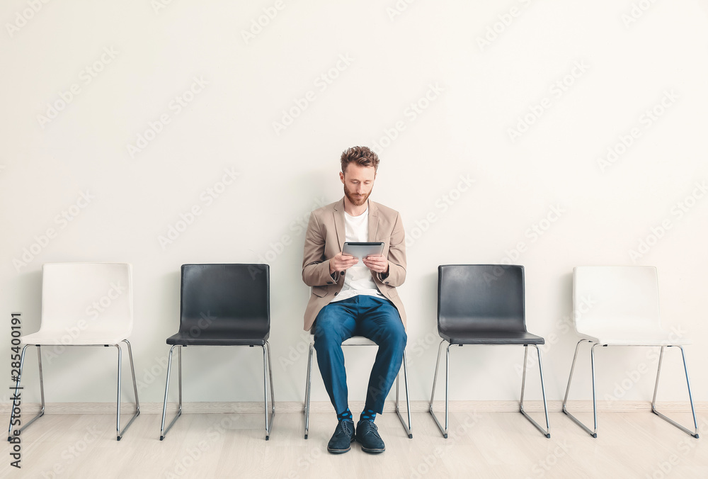 Young man waiting for job interview indoors Young man waiting for job interview indoors