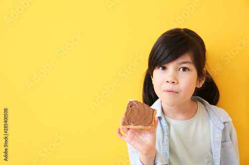 Funny little girl eating ta...