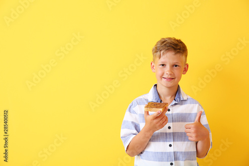 Funny little boy holding ta...