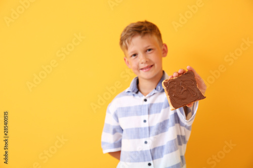 Funny little boy holding ta...