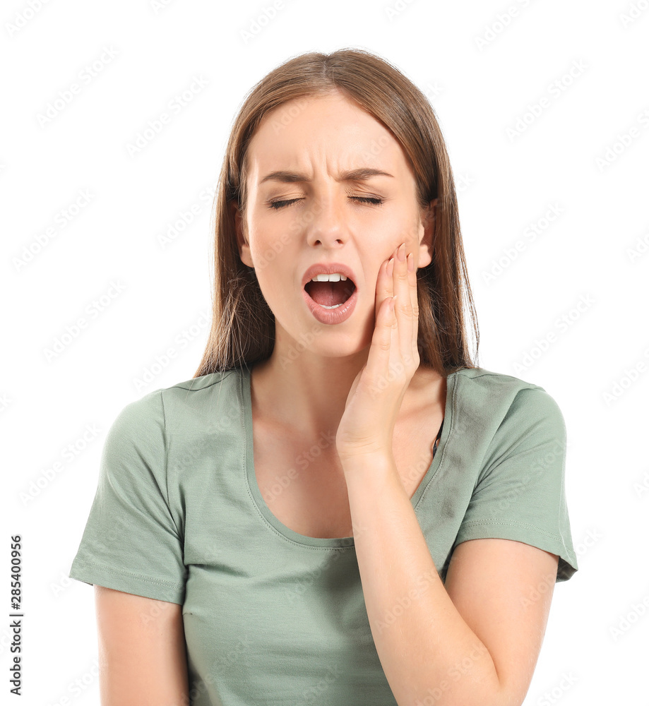 Young woman suffering from toothache against white background