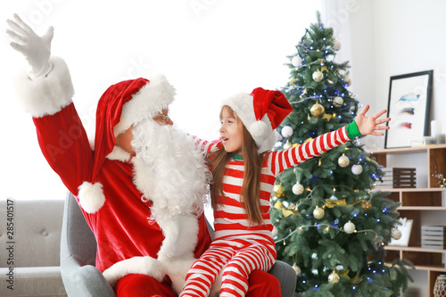 Wallpaper Mural Santa Claus and little girl in room decorated for Christmas Torontodigital.ca