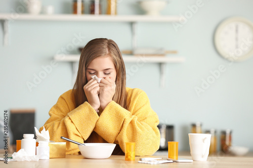 Sick woman at kitchen table