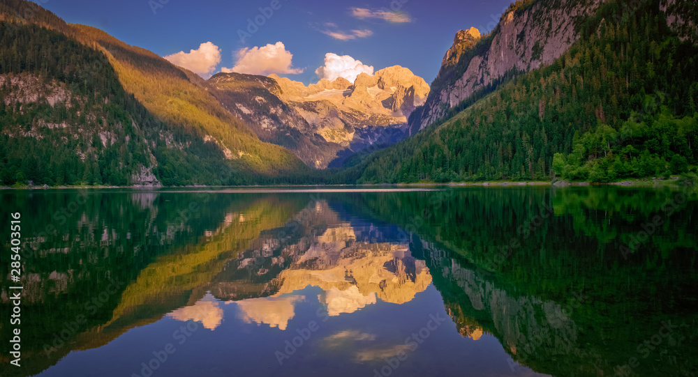 Amazing azure alpine lake Vorderer Gosausee. Picturesque and gorgeous Sunset.