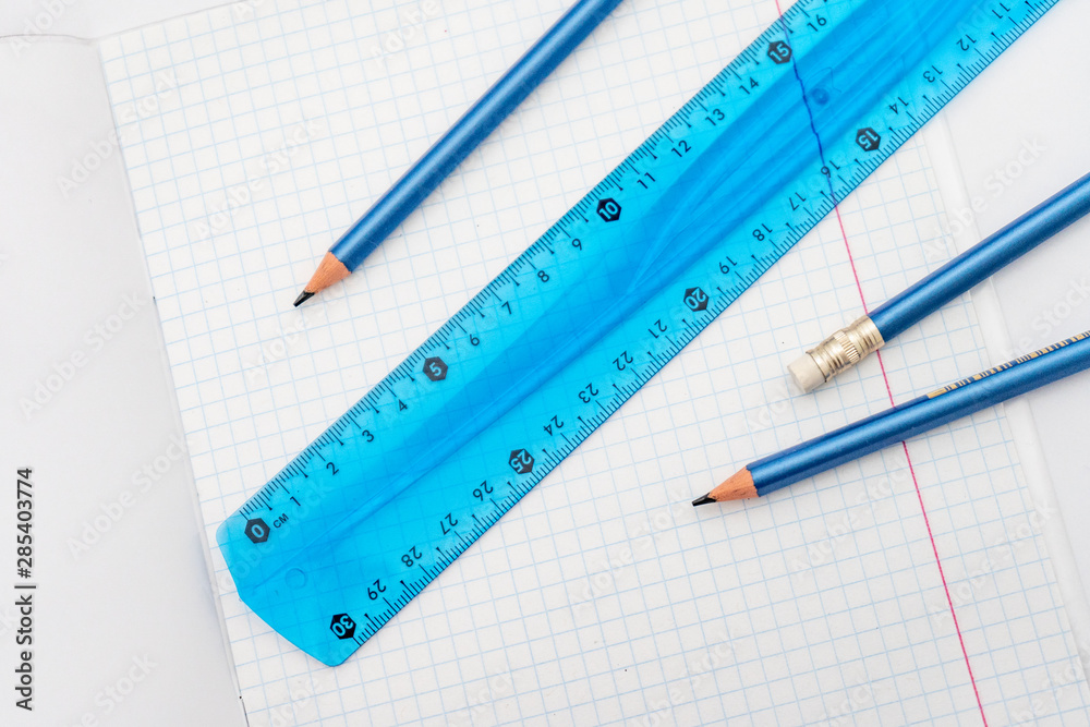 open school notebook with a simple pencil and a ruler on a white table. back to school open school notebook with a simple pencil and a ruler on a white table. back to school