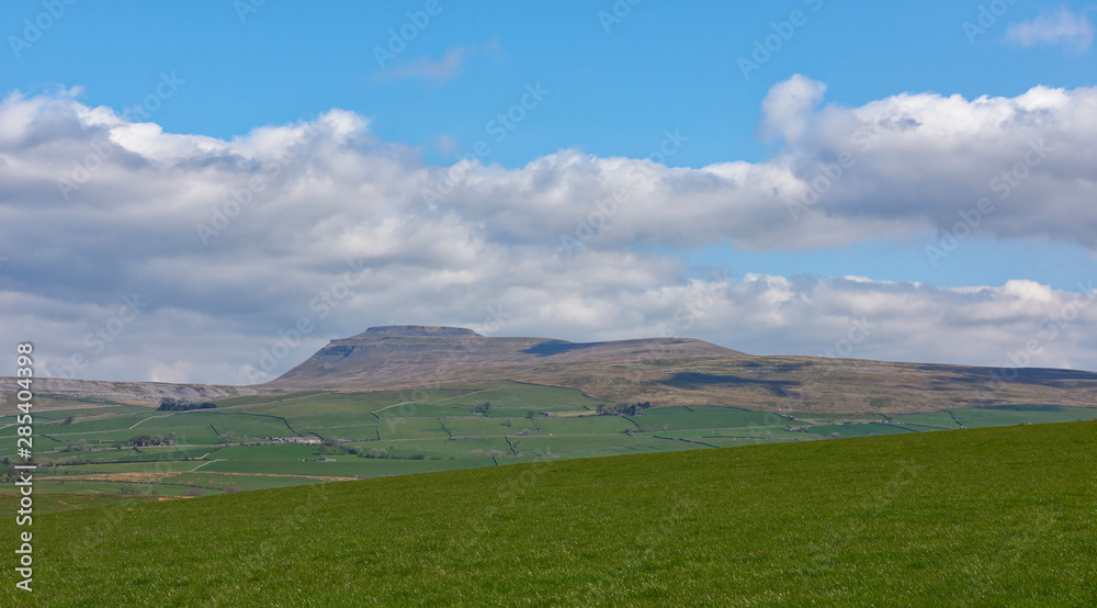 The Mountain of Whernside in the Yorkshire Dales National Park taken looking north on a Spring day in April, with its steep West side. Kirby Lonsdale, England.