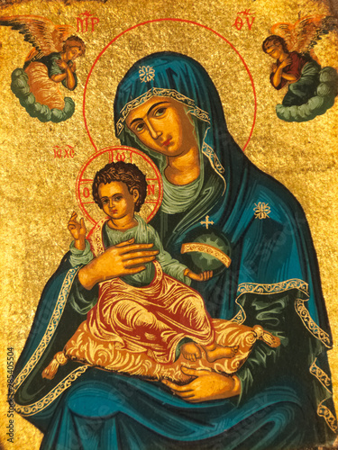 Madonna and child icon. Golden background with angels.