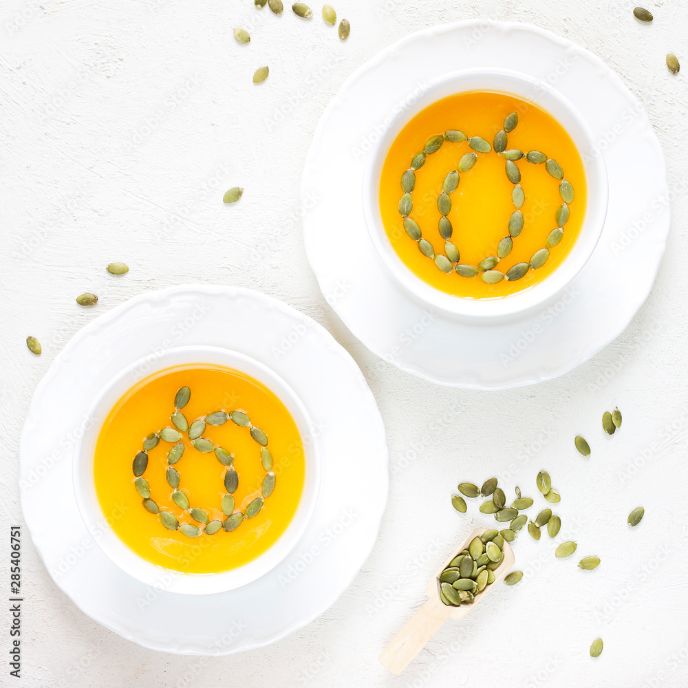 Pumpkin soup with parsley on a white wooden background Pumpkin soup with parsley on a white wooden background