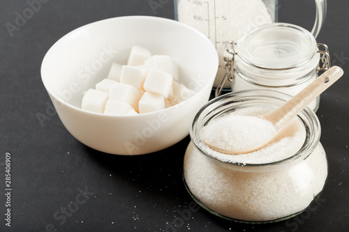 bowl of sugar on black background