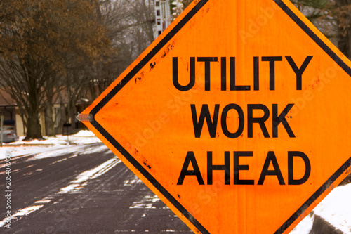 Utility work ahead road construction warning sign.