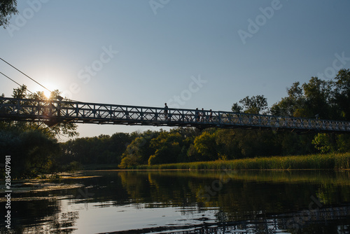 Bridge on river in sunset lights.