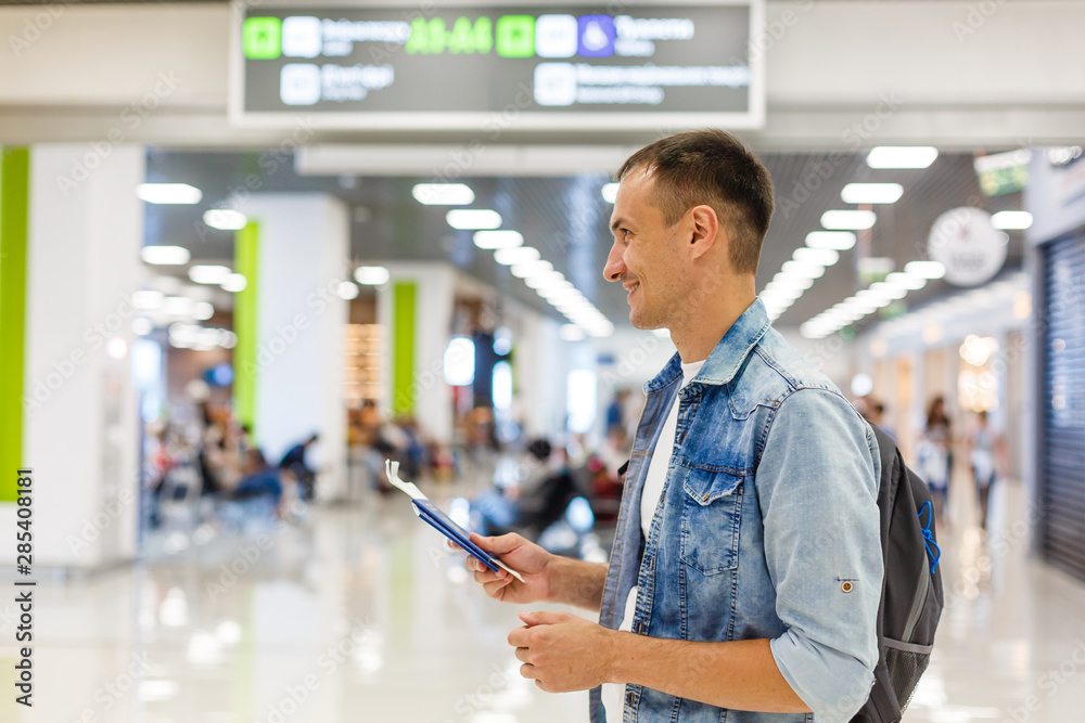Fototapeta premium portrait of a happy male traveler walking with backpack