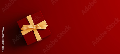Mock-up poster, dark red colored gift box with golden bow on dark red background, 3D Render, 3D Illustration photo