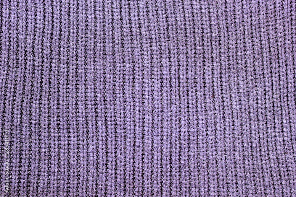 Fototapeta premium stack of cozy knitted sweaters on wooden background. Autumn-winter concept,Knitted wool sweaters. Pile of knitted winter clothes on marble background, sweaters, knitwear, space for text