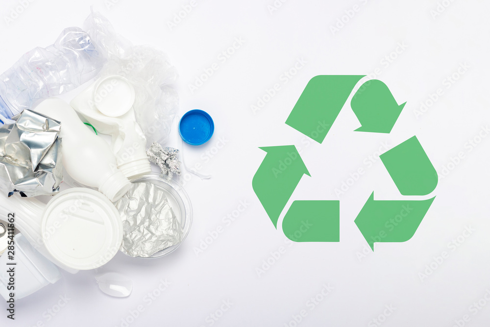 Garbage collection, plastic and metal on a white background. Concept stop plastic, recycling, separate collection of garbage. Flat lay, top view Garbage collection, plastic and metal on a white background. Concept stop plastic, recycling, separate collection of garbage. Flat lay, top view