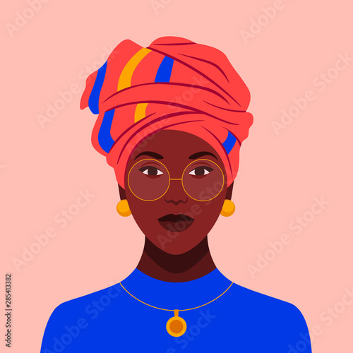 African woman in glasses and a traditional headdress. Avatar of a girl with a scarf on her head  for a social network. Portrait. Vector flat illustration